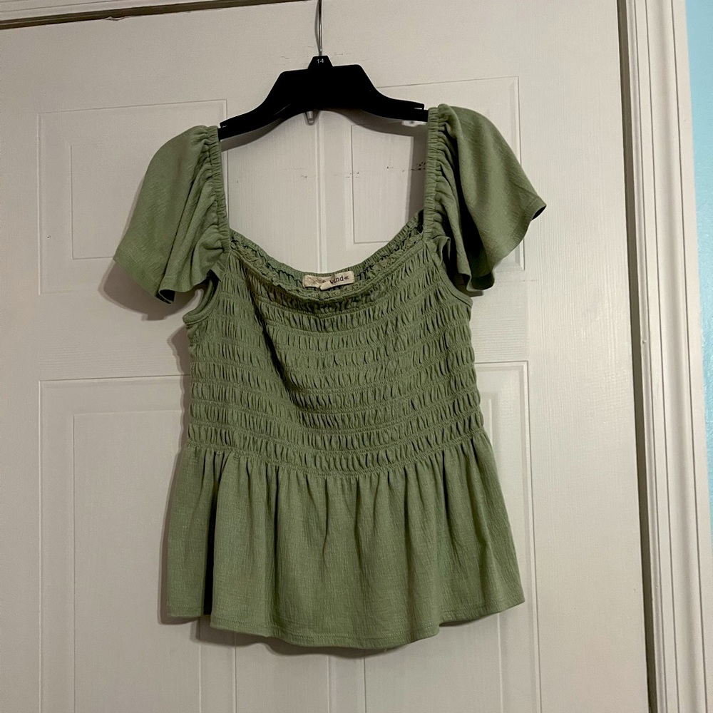 A cute, flattering, sage green, flowy shirt